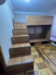 Двухъярусная кровать из ЛДСП с полками, ящиками и встроенным шкафом