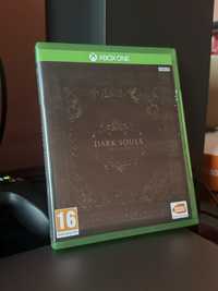 Xbox диск с игрой Dark Souls Trilogy.